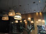 many lights hanging from the ceiling in a restaurant
