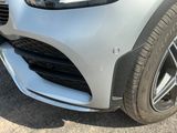 a close up of the front bumper of a silver car