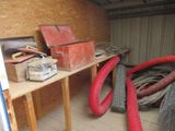 some red hoses are sitting on a wooden table in a room