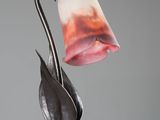a lamp that is sitting on a table with a flower on it