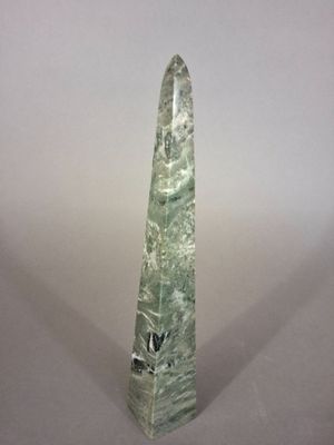 an image of a green stone obelisk on a white background