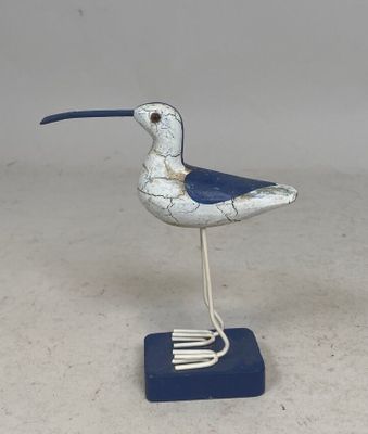 a small bird that is standing on a blue stand