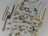 many different types of necklaces and bracelets on the table
