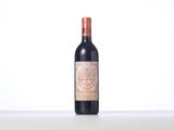 a bottle of red wine sitting on top of a table