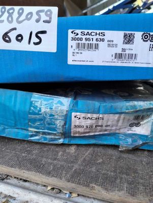 a blue box with a label on it sitting on top of a pile of other boxes