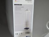 a white box that is sitting next to a lamp
