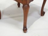 a wooden table with a glass top on a white surface