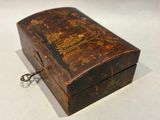 a small wooden box with a chain hanging from it