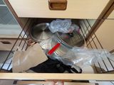 a metal pan sitting in the bottom drawer of a cabinet