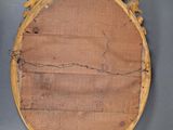 an antique wooden mirror with a carved frame and a wooden plaque