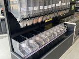 a display case with many containers of food inside of it