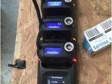 several cell phones are lined up on a table with a box of batteries