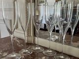 several empty wine glasses are lined up on a marble counter