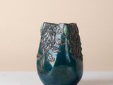 a blue vase that is sitting on a table