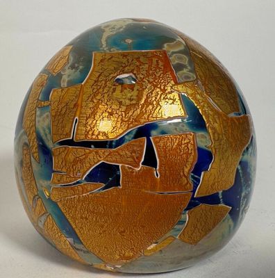 a gold and blue vase with a fish design on it