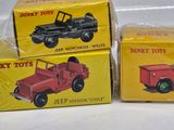 three boxes of toy vehicles are sitting on a white surface