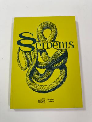 the serpents book is sitting on a white surface