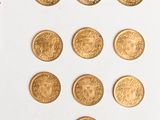 a lot of gold coins on a white surface