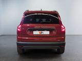 the back end of a red suv parked in a white room