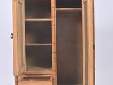 a small wooden cabinet with a door and shelves