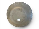 a gray bowl on a white surface with a sticker on it