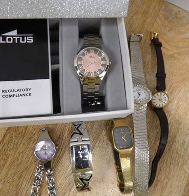 a lot of watches and bracelets in a box on a table