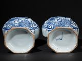 pair of blue and white vases with floral designs on them