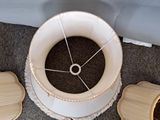 an overhead view of a lamp with a white shade on it