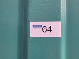a sticker on the side of a green metal door