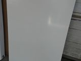 a white refrigerator and a white refrigerator freezer in a garage