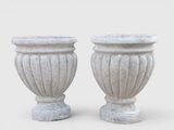 pair of white stone urns on a white background