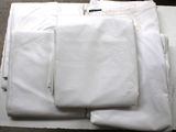 a lot of white shirts and pants on a table