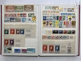 an open book with stamps on it on a table