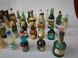 many bottles of alcohol sitting on a white table