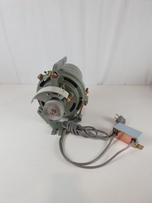 a close up of a small motor on a white surface