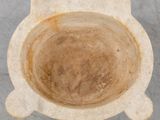 an overhead view of a stone bowl on a concrete surface