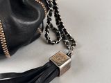 a close up of a black purse with a chain around it