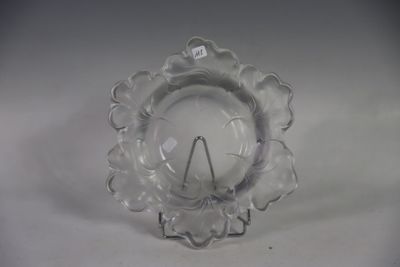 a clear glass candle holder on a white table