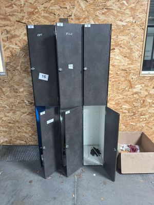 four black lockers sitting next to each other on the floor