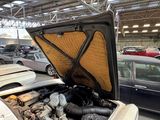a car that is parked in a garage with its hood open