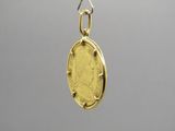 a close up of a gold coin hanging from a chain