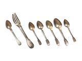 six silver spoons and a fork are lined up on a white surface