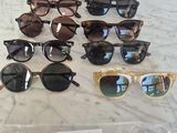 several pairs of sunglasses are on display on a marble table