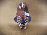 a figurine of a man with a bird on his head