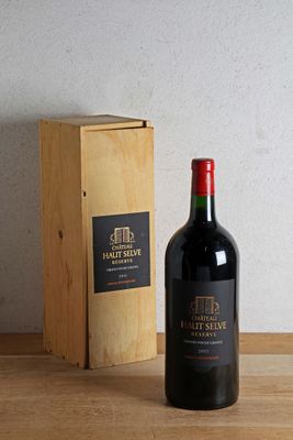 a bottle of wine sitting next to a wooden box on a table
