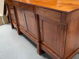a large wooden cabinet in the middle of a room