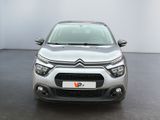 the front of a silver citrole parked in a white room