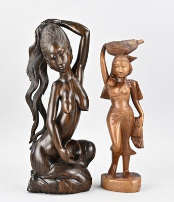 pair of bronze figurines of a woman with a basket on her head and a woman with a basket on her head