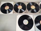 three black vinyl records sitting on top of a table next to each other