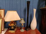 two vases and a lamp on a table next to a picture